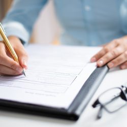 Closeup of entrepreneur making notes in document